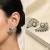Magan Pearls & Jewels Green Stone and Pearl Stud Earrings with American Diamonds, Elegant Fan Design for Wedding