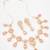 festive rose gold pink floral bib necklace set with stone drops and flower cluster earrings