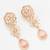 festive rose gold pink floral bib necklace set with stone drops and flower cluster earrings