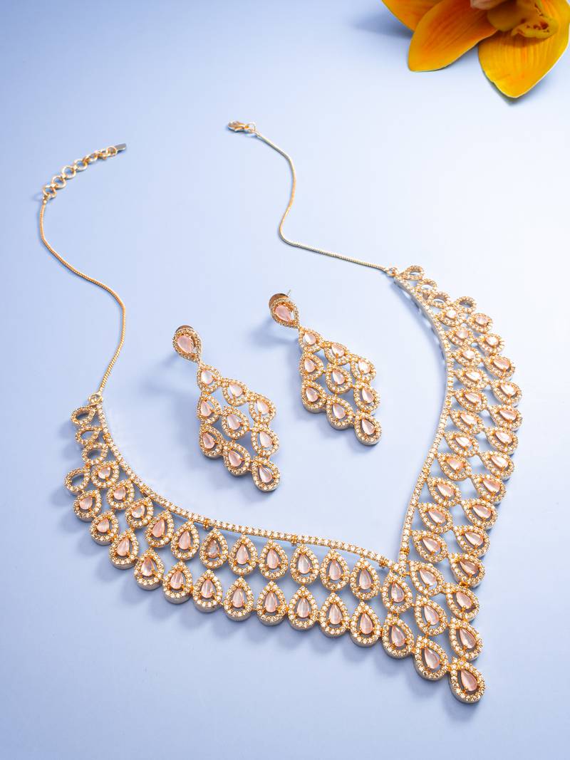 party wear rose gold peach necklace set with cascading bib design and chandelier drop earrings
