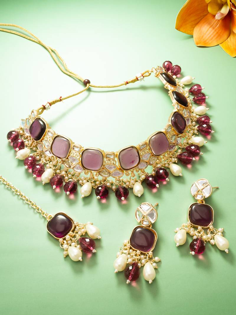 gold plated kundan choker necklace set with purple stone, pearl drop earrings and maang tikka