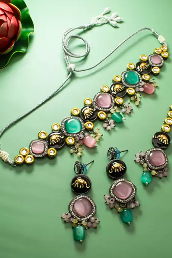 oxidized silver elephant motif choker necklace set with catseye stones, earrings and maang tikka