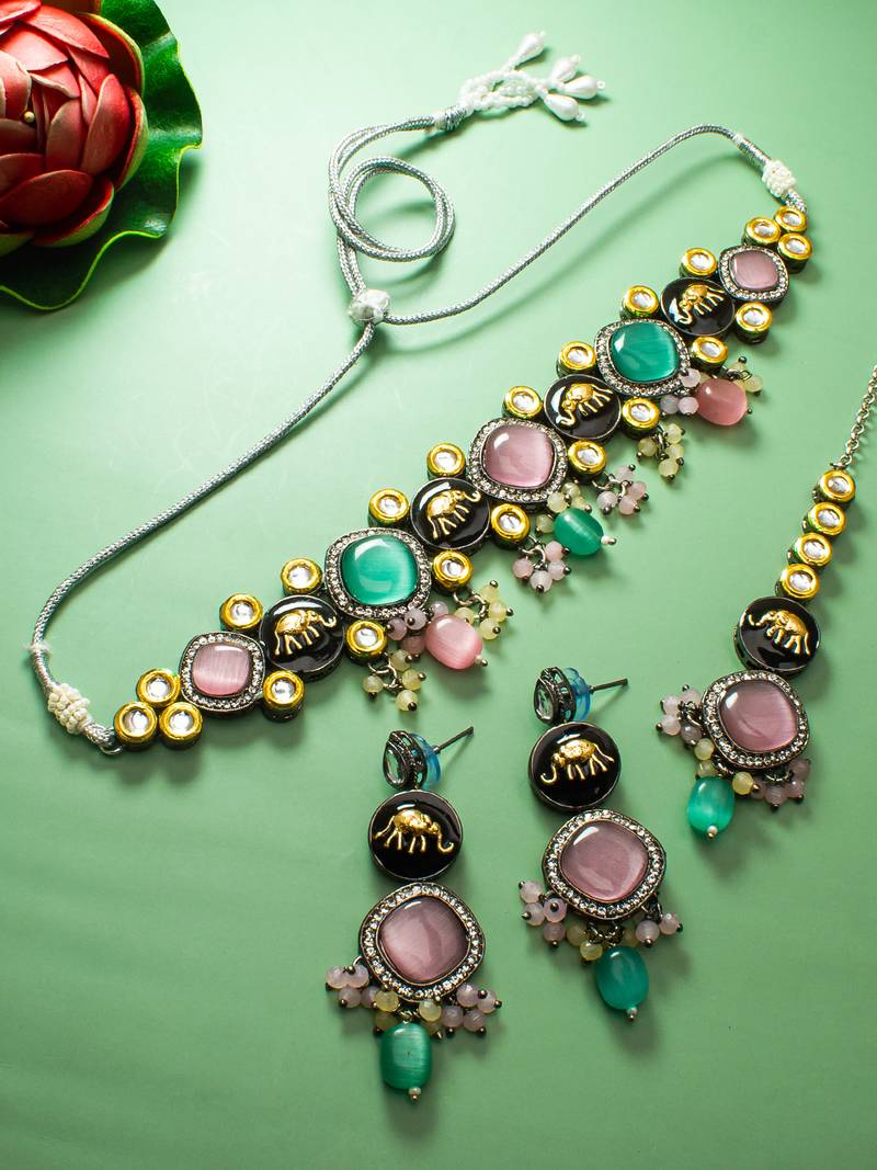 oxidized silver elephant motif choker necklace set with catseye stones, earrings and maang tikka