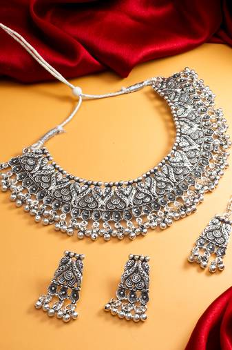 oxidized silver leaf and floral bib choker necklace set with ghungroo earrings and maang tikka
