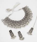 oxidized silver floral panel choker necklace set with ghungroo drops, earrings and maang tikka