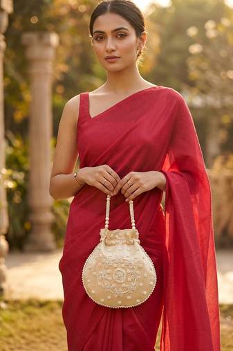 Elegant cream peach pearl embroidered potli bag with beaded handle