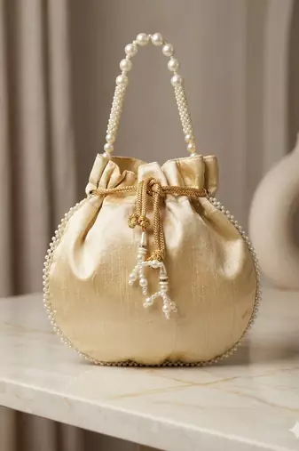 Elegant cream peach pearl embroidered potli bag with beaded handle