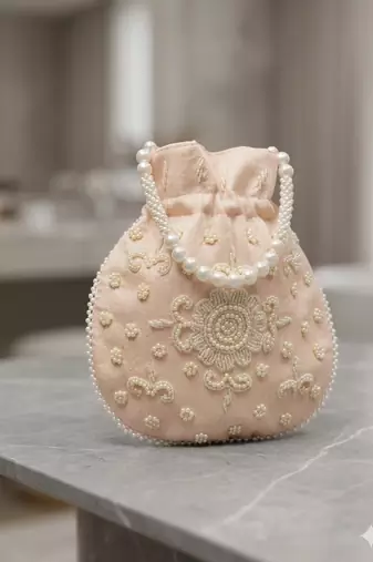 Luxury pastel peach pearl embroidered potli bag with beaded handle     bridal & festive clutch