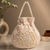 Elegant beige embroidered potli bag with beaded handle