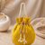 Elegant yellow pearl embroidered potli bag with beaded handle