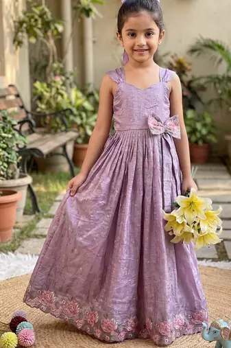 New trendy girls elegant white crinkled ethnic gown with pink lotus border and stylish waist bow