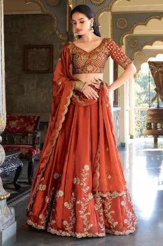 Rust orange Vichitra silk lehenga choli set featuring intricate sequins and thread embroidery