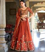 Rust orange Vichitra silk lehenga choli set featuring intricate sequins and thread embroidery