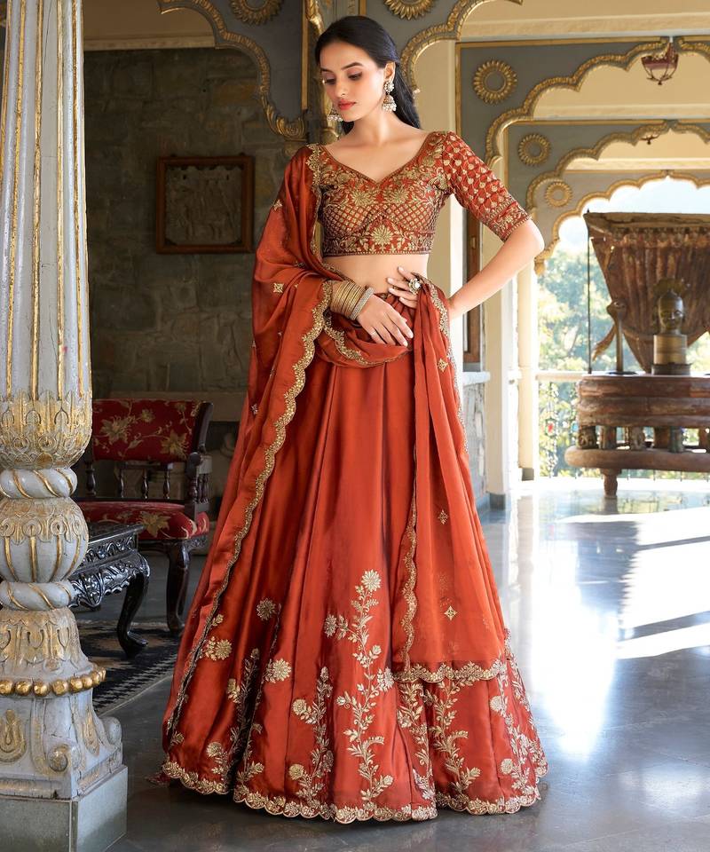 Rust orange Vichitra silk lehenga choli set featuring intricate sequins and thread embroidery