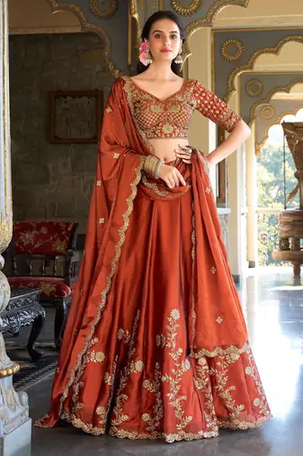 Rust orange Vichitra silk lehenga choli set featuring intricate sequins and thread embroidery