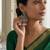 Gold plated-tone lotus motif jhumki necklace set with emerald-green accents