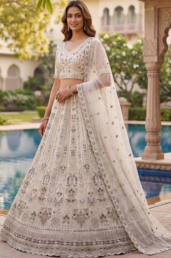 Charming Cream Embroidered Net Engagement Wear Lehenga Choli