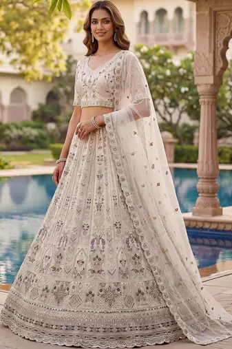 Charming Cream Embroidered Net Engagement Wear Lehenga Choli