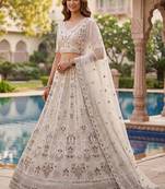 Charming Cream Embroidered Net Engagement Wear Lehenga Choli