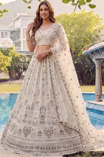 Charming Cream Embroidered Net Engagement Wear Lehenga Choli
