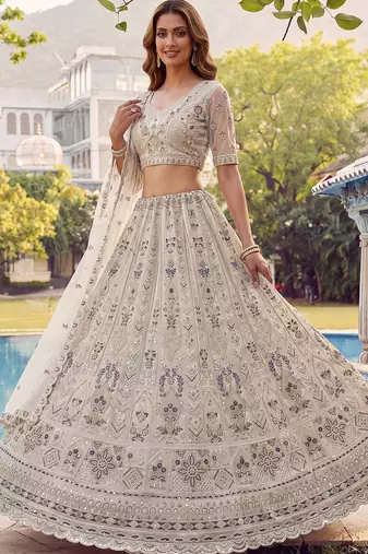 Charming Cream Embroidered Net Engagement Wear Lehenga Choli