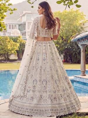 Charming Cream Embroidered Net Engagement Wear Lehenga Choli 4