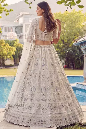 Charming Cream Embroidered Net Engagement Wear Lehenga Choli