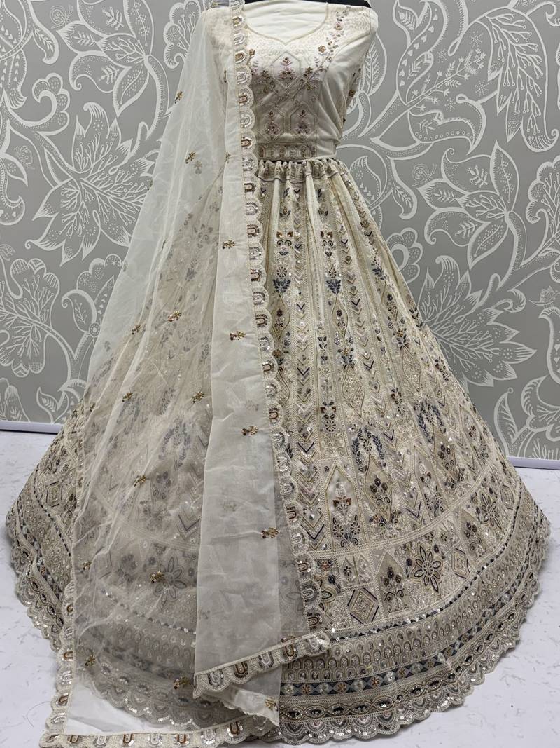 Charming Cream Embroidered Net Engagement Wear Lehenga Choli