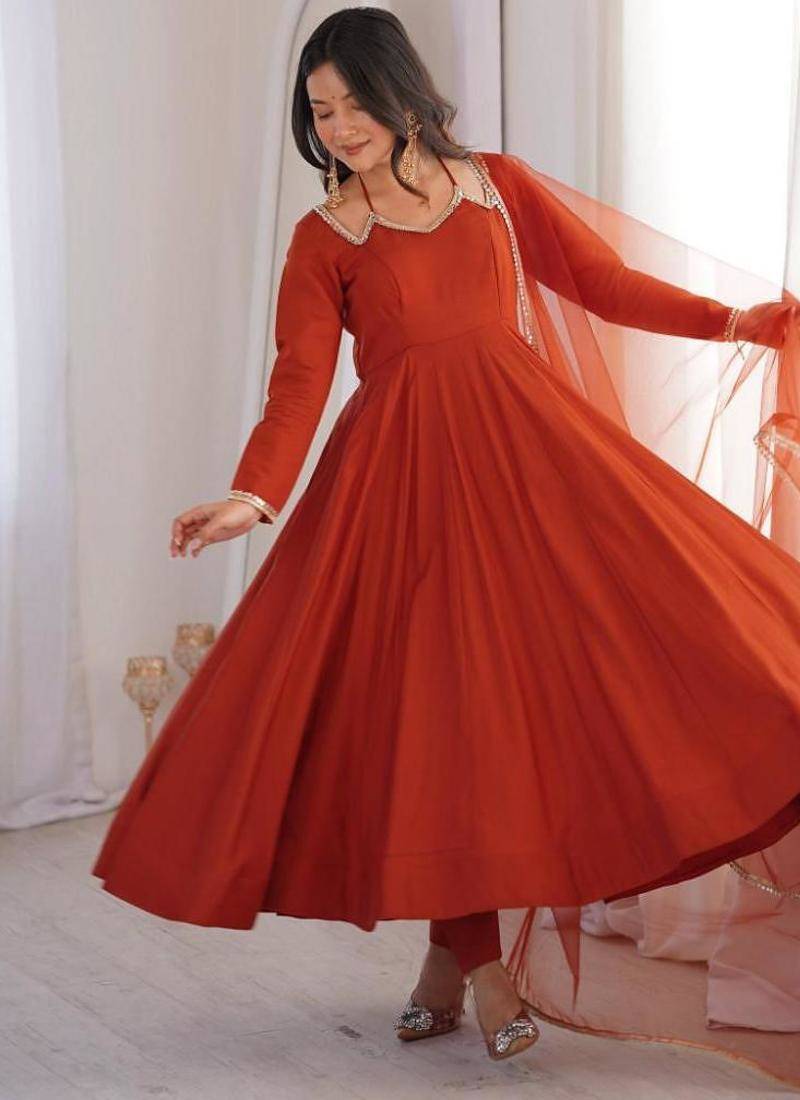 Rust color roman silk chanderi solid -mirror lace work anarkali set full stitched.
