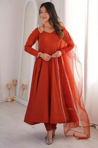 Rust color roman silk chanderi solid -mirror lace work anarkali set full stitched.
