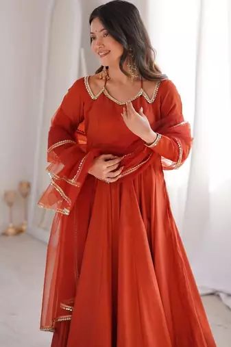 Rust color roman silk chanderi solid -mirror lace work anarkali set full stitched.