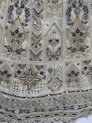 Charming Cream Embroidered Net Engagement Wear Lehenga Choli 9