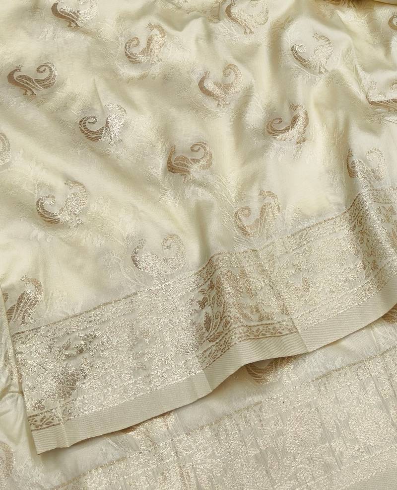 Cream zari woven banarasi silk blend saree with blouse piece