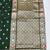 Dark green zari woven banarasi silk blend saree with blouse piece