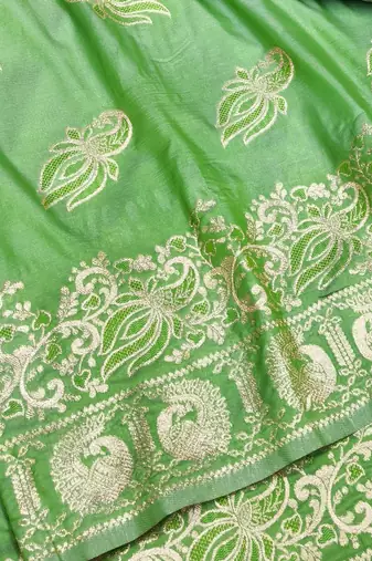 Green zari woven silk blend saree with blouse piece