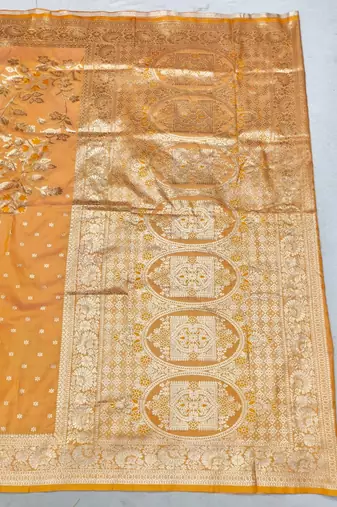 Light orange zari woven silk blend saree with blouse piece