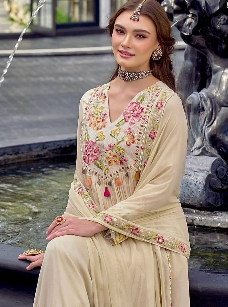 Beautiful  beige anarkali suit set featuring detailed floral thread work and embroidered dupatta.