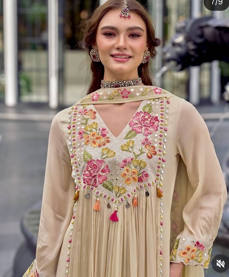 Beautiful  beige anarkali suit set featuring detailed floral thread work and embroidered dupatta.