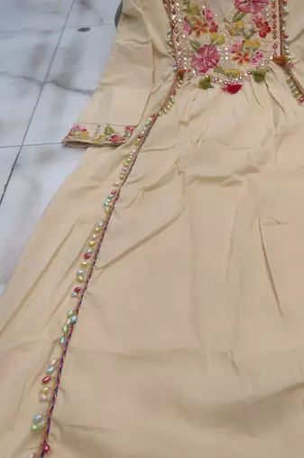 Beautiful  beige anarkali suit set featuring detailed floral thread work and embroidered dupatta.