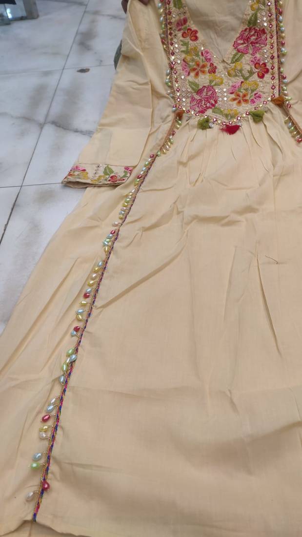 Beautiful  beige anarkali suit set featuring detailed floral thread work and embroidered dupatta.