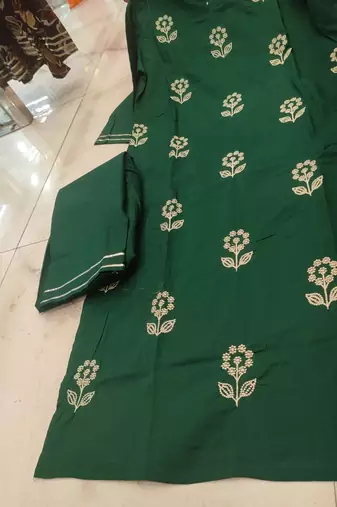Beautiful  a dark green cotton kurta pant set featuring white floral embroidery and a matching dupatta