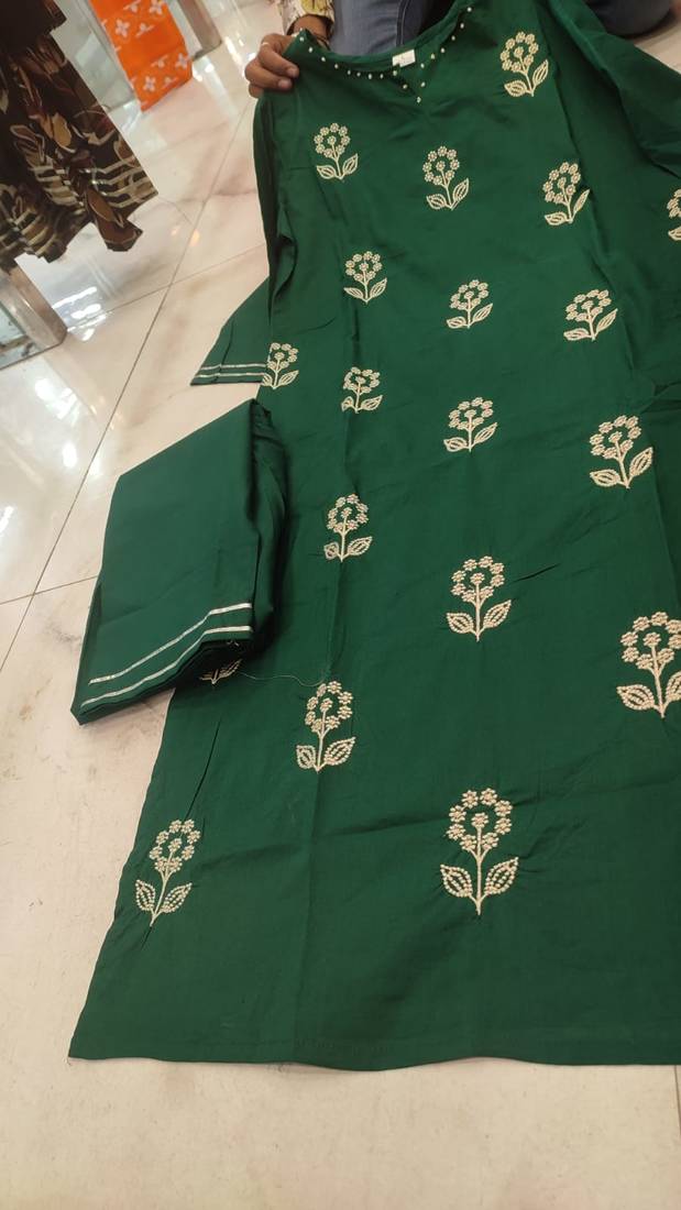 Beautiful  a dark green cotton kurta pant set featuring white floral embroidery and a matching dupatta