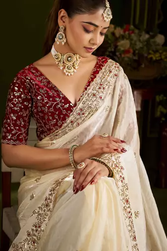 Beige satin silk saree with red embroidered blouse