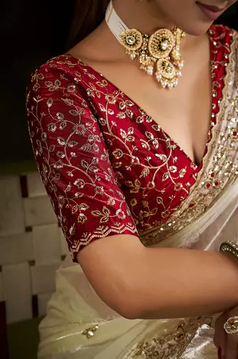 Beige satin silk saree with red embroidered blouse