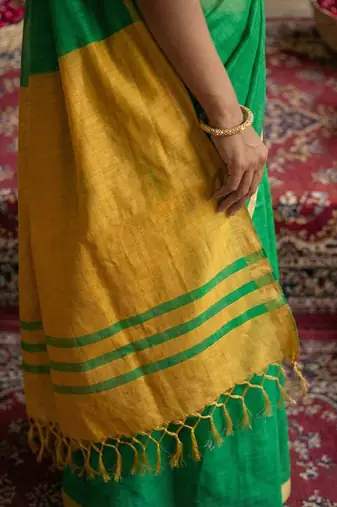 Green colour handloom cotton saree with contrast border & tassels