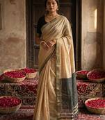 Beige colour handloom cotton saree with contrast border & tassels