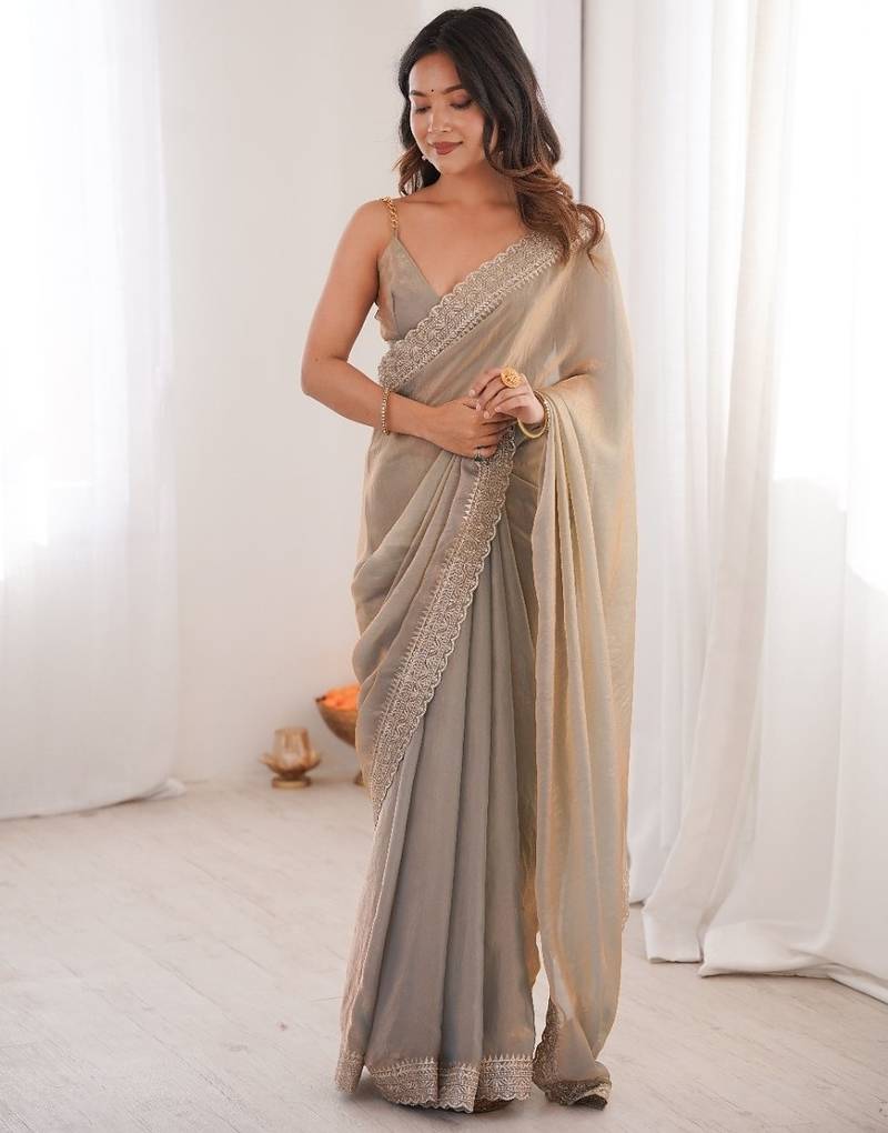 Beige colour fendy satin embroidered lace border saree