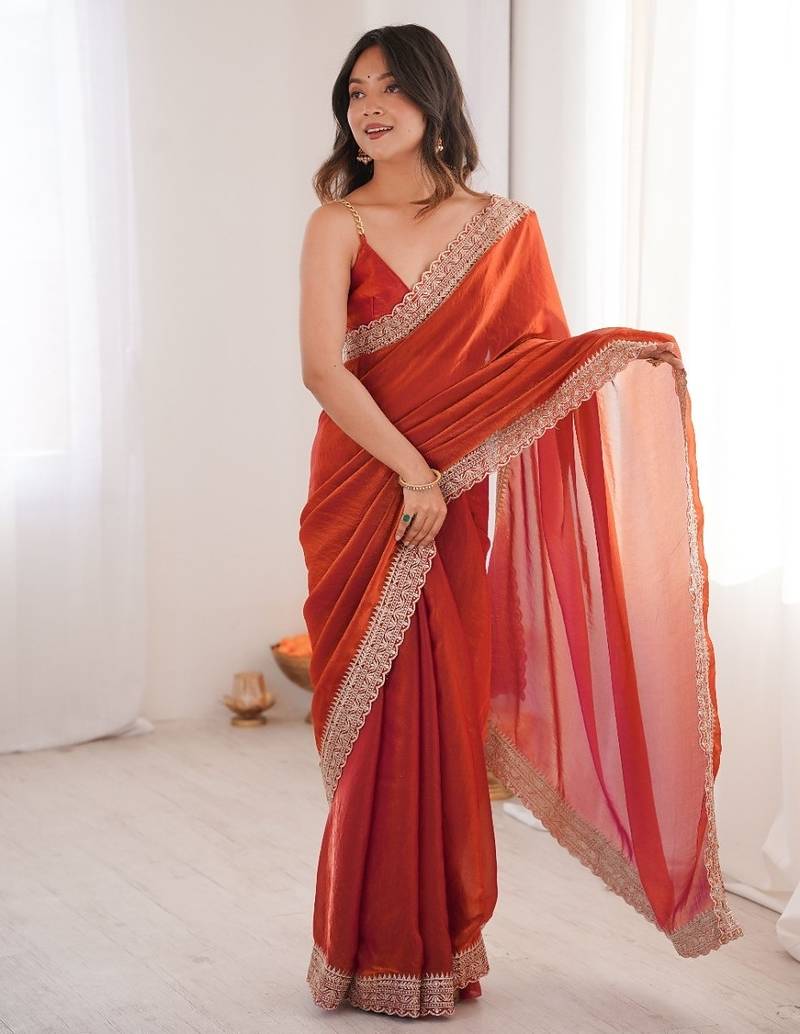 Orange colour fendy satin embroidered lace border saree