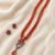 Red beads maala set with flower pendant, multi-strand necklace with matching stud earrings