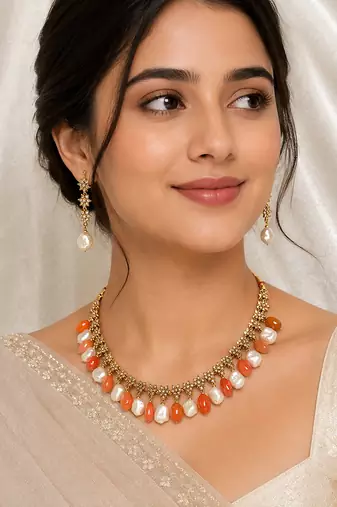 Gold-toned necklace set with orange beads and baroque pearls, ethnic indian jewellery, with earrings